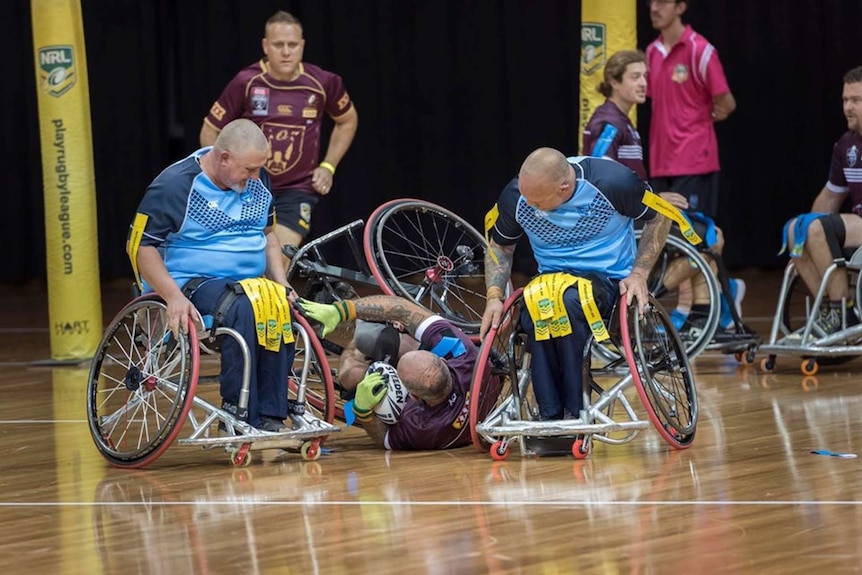 A group of people playing wheelchair rugby.