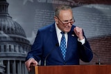 Chuck Schumer pumps his fist in celebration of the bill passing.