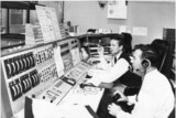 John Saxon and Mike Dinn at the Ops console at Honeysuckle Creek.