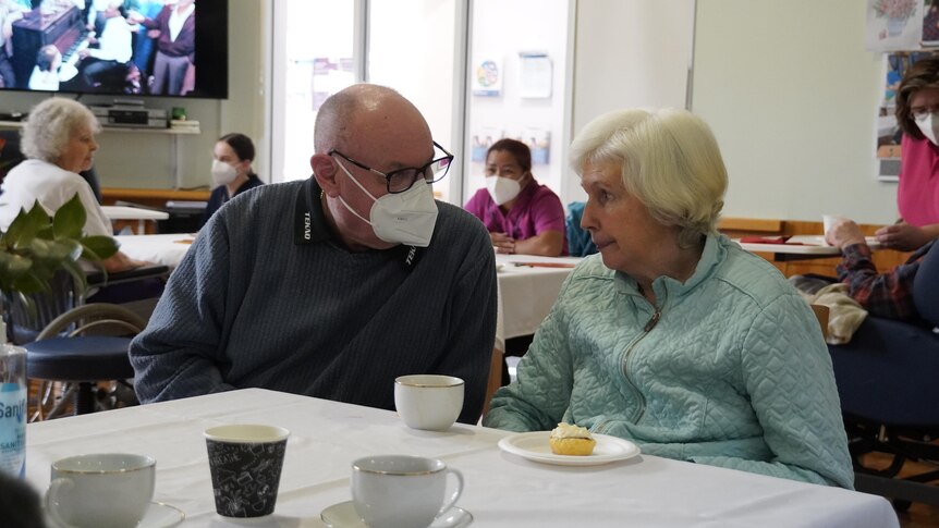 Brian Ridge and Denise Brown talk to each other over a cup of coffee and a scone