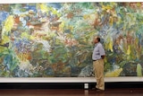 Tim Jennings inspects Earth Creation by Emily Kame Kngwarreye