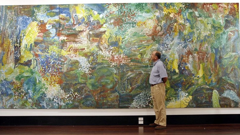 Tim Jennings inspects Earth Creation by Emily Kame Kngwarreye