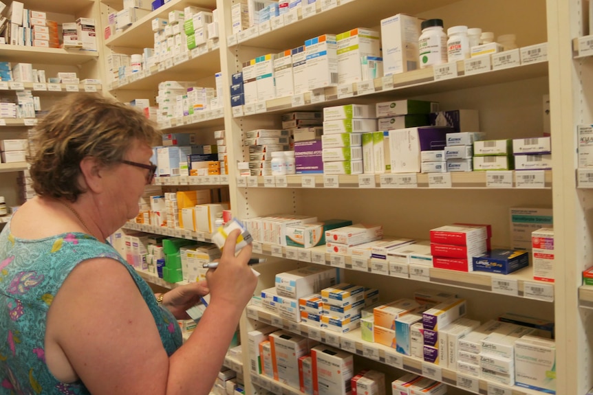 a woman standing in front of a shelf