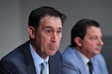James Sutherland speaking to the media with David Peever in the background.