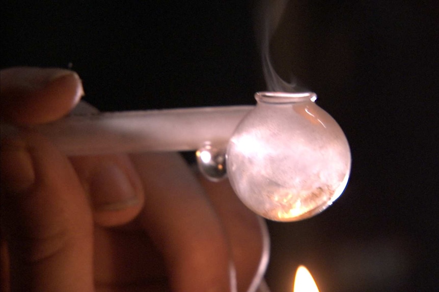 Video still - someone smoking a crystal meth pipe, October 2014.