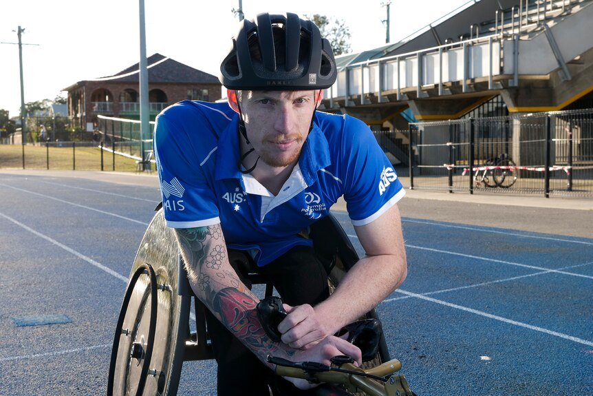 Luke Bailey in his racing wheelchair on a racing track