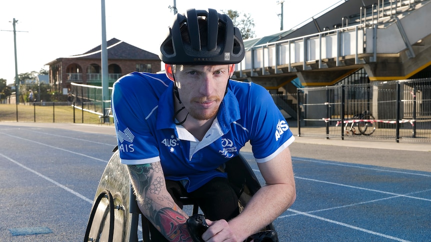 Luke Bailey in his racing wheelchair on a racing track.