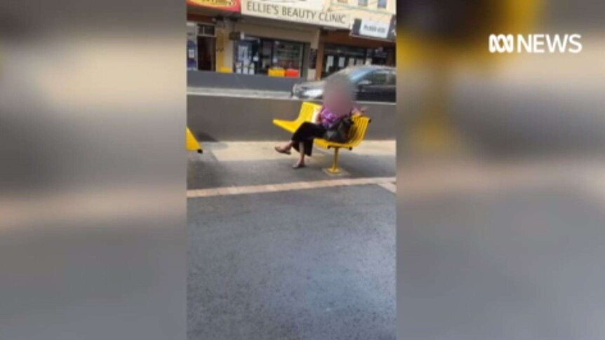 An image taken from video showing a woman sitting on a bench outside a bubble tea shop in the Melbourne suburb of Carnegie.