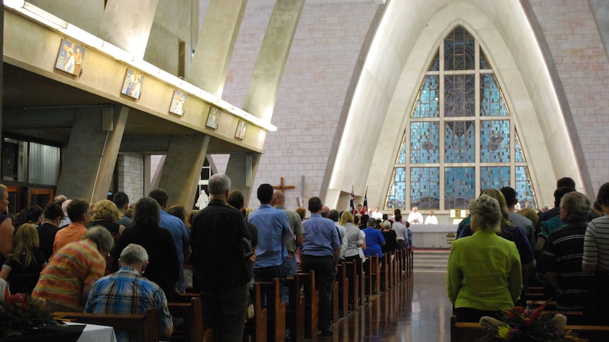 People gather in a Darwin church to remember those who died on flight MH17