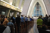 People gather in a Darwin church to remember those who died on flight MH17