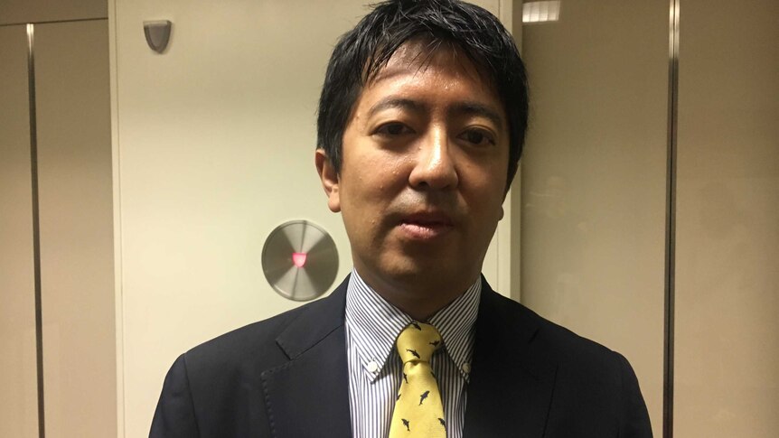 Shigeki Takaya from Japan's fisheries agency wearing a tie with whales on it.