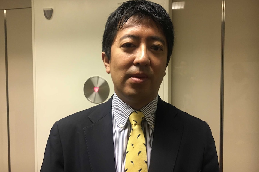 Shigeki Takaya from Japan's fisheries agency wearing a tie with whales on it.