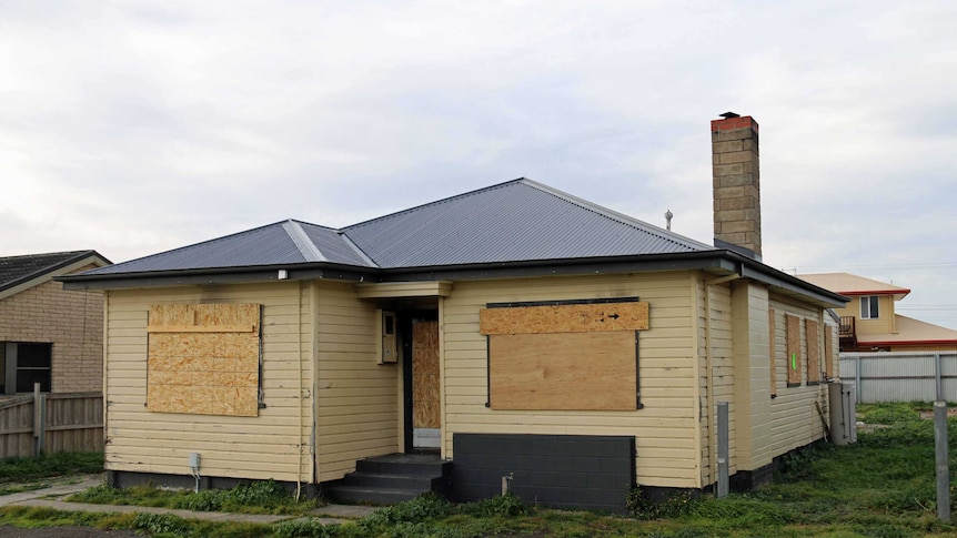 A house boarded up in Goodwood after an arson attack