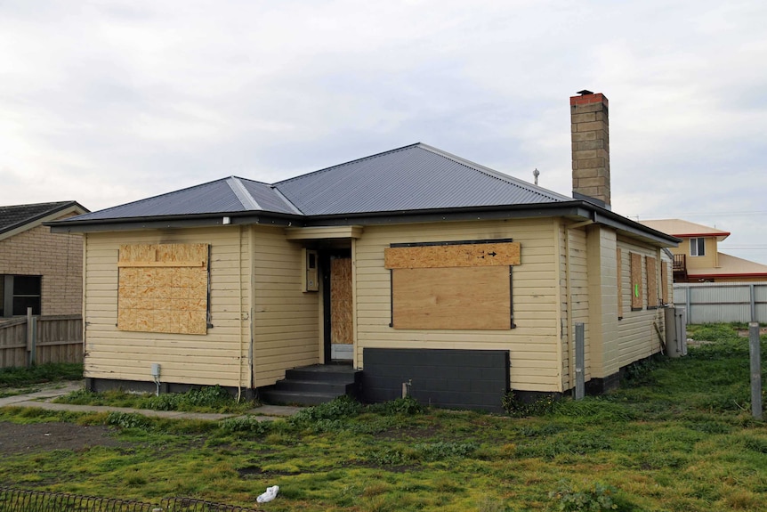 A house boarded up in Goodwood after an arson attack