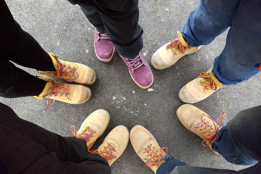 Boots with rainbow laces as part of Wear It Purple Day.