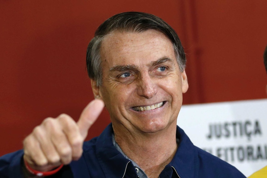 Jair Bolsonaro gives a thumbs up