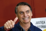 Jair Bolsonaro gives a thumbs up