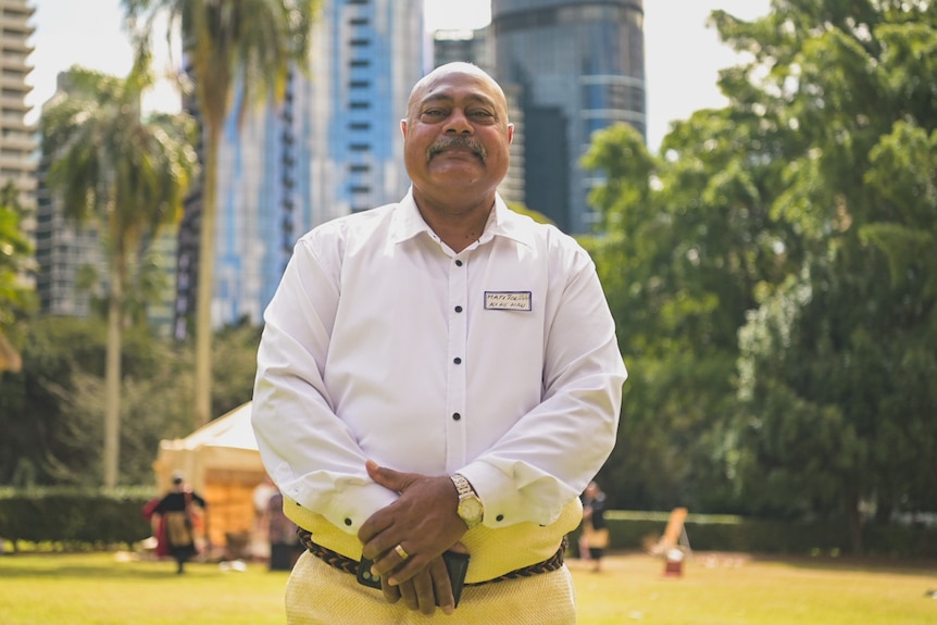 Sione Maile Molitika stands in a park.