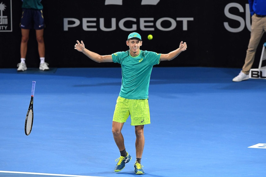 Australia's Alex De Minaur reacts after beating Milos Raonic at the Brisbane International