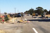 Debris litters Highway One after a serious crash