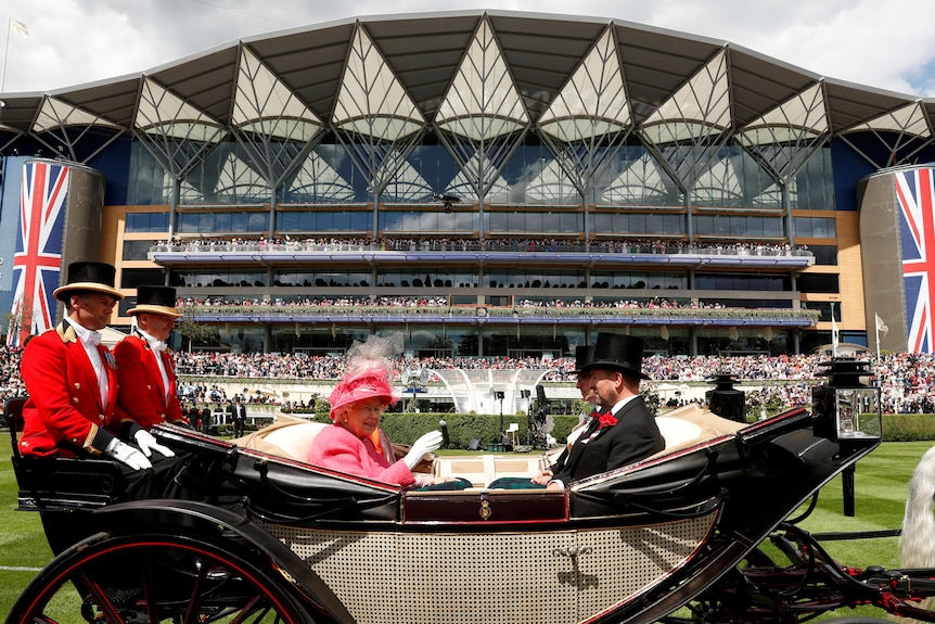 The Queen in an open chariot arrives at Royal Ascot.