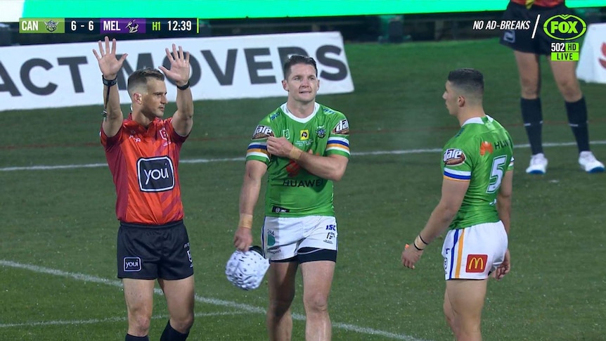Referee Grant Atkins (left) holds up 10 finger as Canberra Raiders captain Jarrod Croker and winger Bailey Simonsson look on.