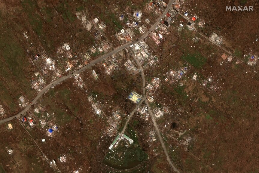 A satellite image of destroyed houses on an island after a hurricane