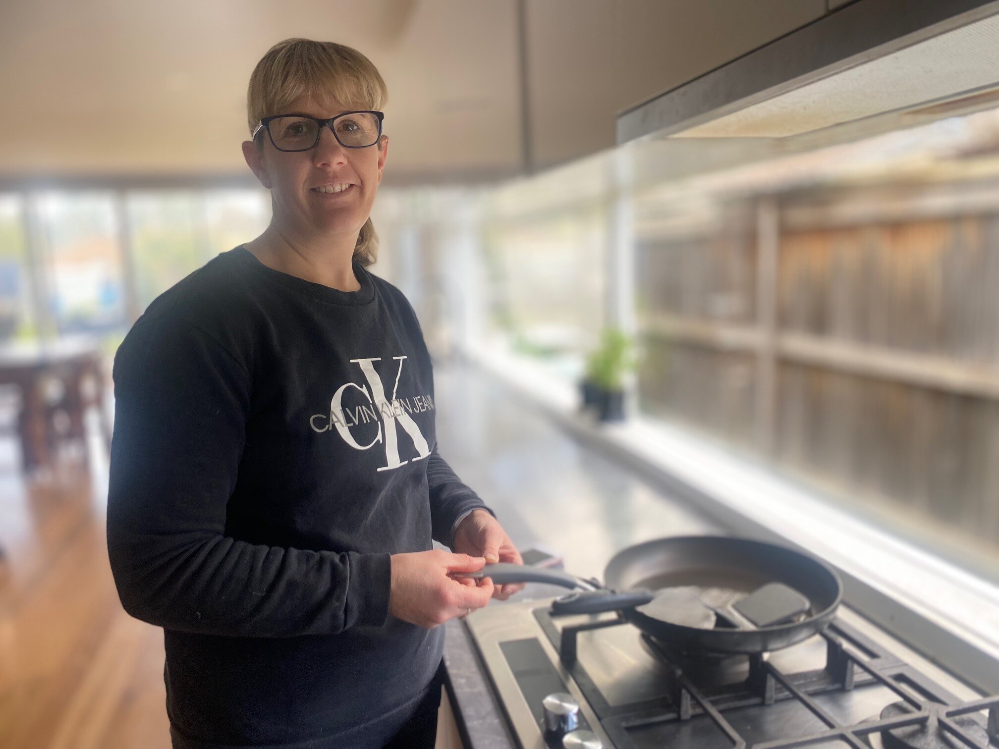 A woman cooking on a gas stove