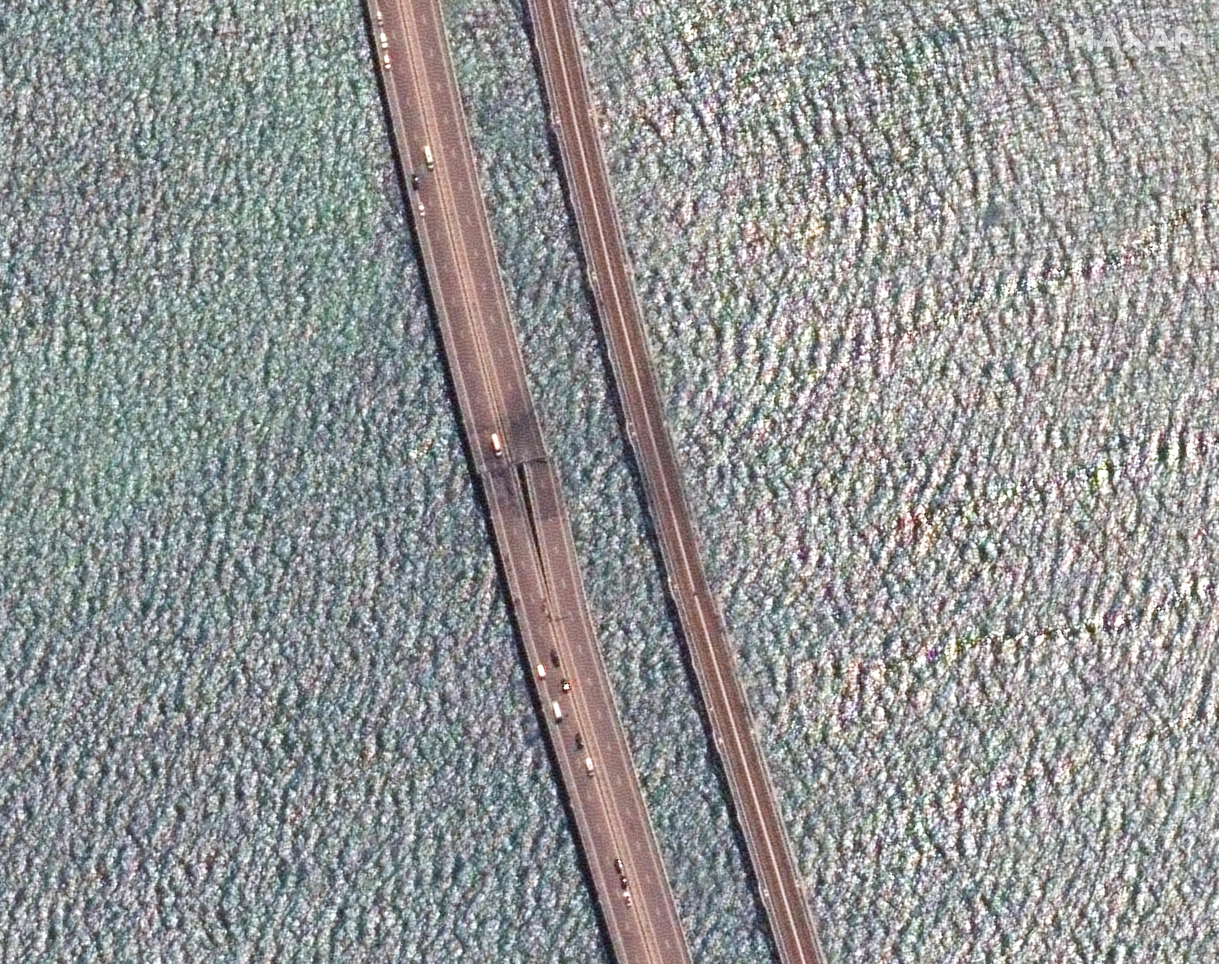A satellite image shows a rotated and close up view of the damaged span of the Crimea bridge.