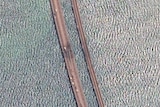 A satellite image shows a rotated and close up view of the damaged span of the Crimea bridge.