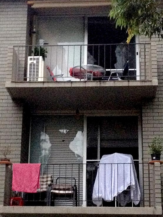 Smashed glass doors in two units at Merrylands.