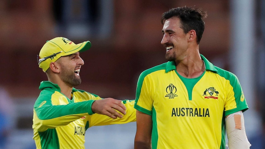 Nathan Lyon and Mitchell Starc are all smiles as Lyon goes to embrace the lanky quick.