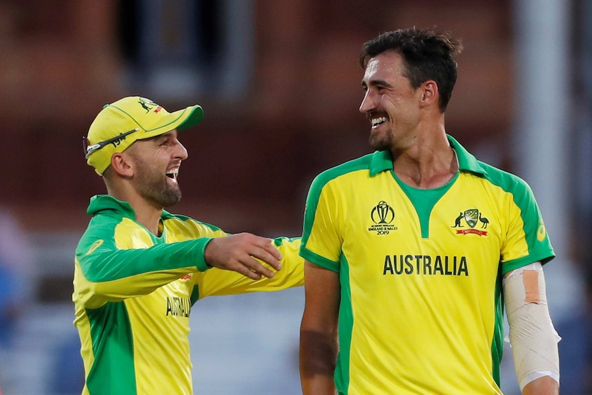 Nathan Lyon and Mitchell Starc are all smiles as Lyon goes to embrace the lanky quick.