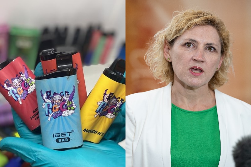 On the left, a pile of nicotine vapes, and on the right, a woman with blonde hair wearing a green top and white blazer.