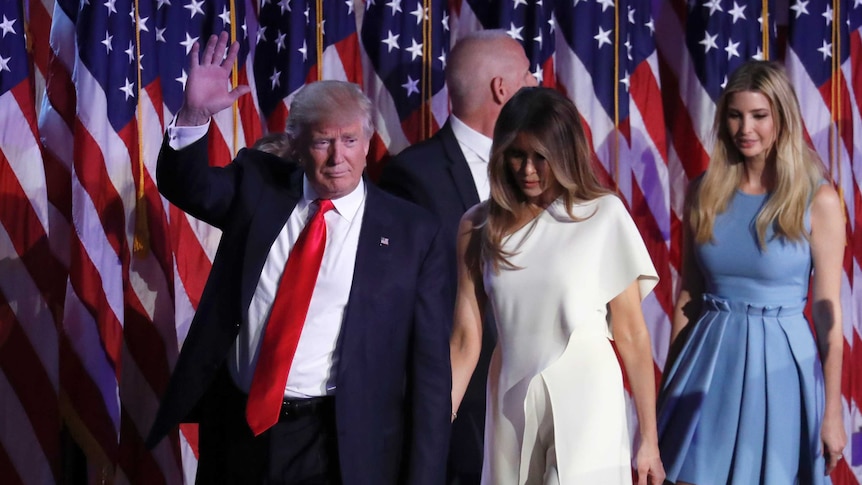 President-elect Donald Trump waves as he walks with his wife Melania Trump followed by his daughter Ivanka Trump.