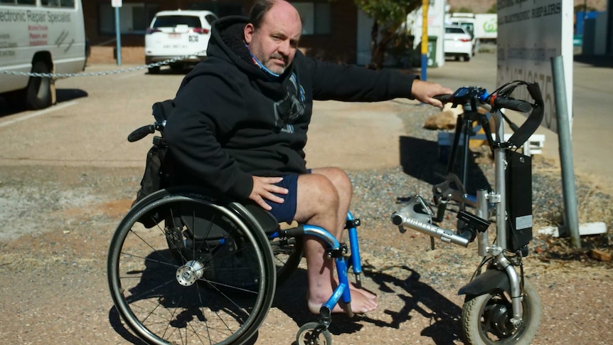 Colin Dawson can travel up to 25 kilometres per hour with this wheelchair aid, but NT Police say this is too fast