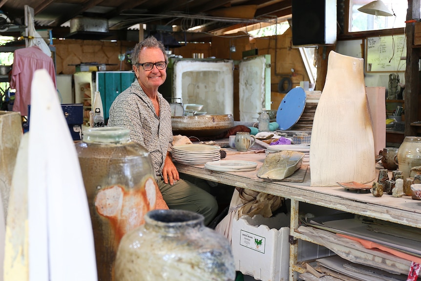 Suvira McDonald sits amongst ceramic works in his studio