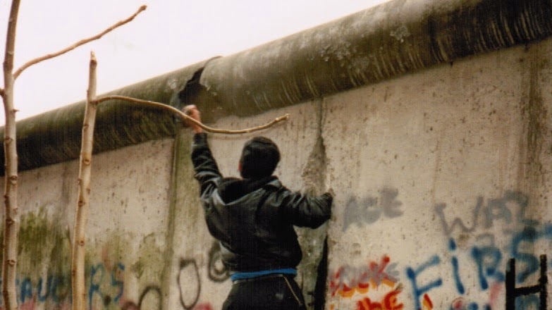 A man chisels into the Berlin Wall in November 1989.