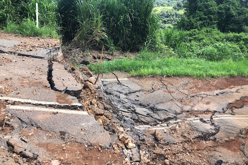 a crumbled road drops down two metres
