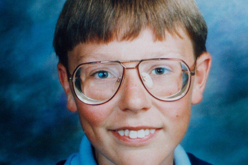 A school photo from the 1980s of Justin Heazlewood, a blonde boy with glasses.