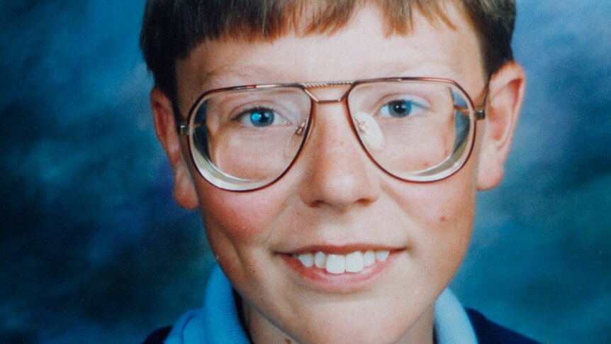 A school photo from the 1980s of Justin Heazlewood, a blonde boy with glasses.