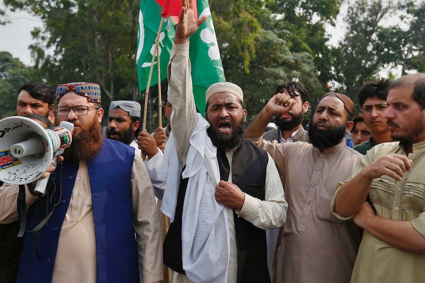 Supporters of a Pakistani religious group chant slogans during a protest after a court decision