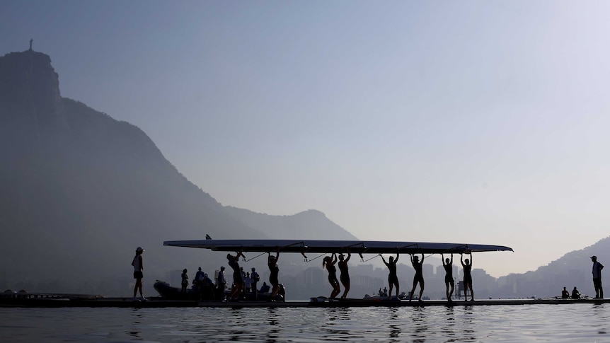 Rowing athletes carry their boat ahead a training session at the World Rowing Junior Championships in Rodrigo de Freitas Lagoon