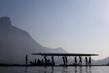 Athletes carry their boat ahead of a training session at the World Rowing Junior Championships in Rodrigo de Freitas Lagoon.