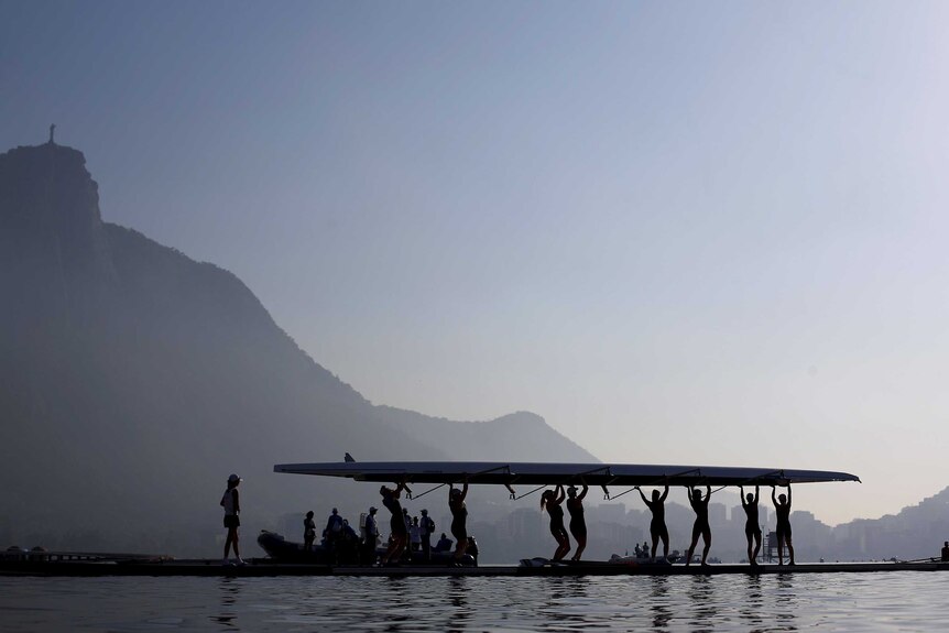 Rowing athletes carry their boat ahead a training session at the World Rowing Junior Championships in Rodrigo de Freitas Lagoon