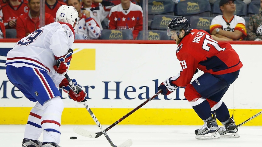 Nathan Walker skates with the puck against defenseman Victor Mete.