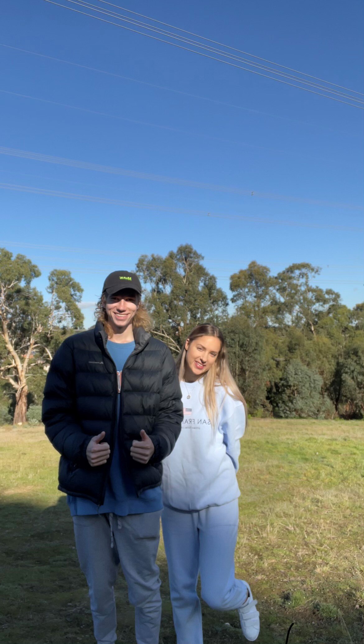 Rachel and Jarryd smile at the camera, in a story about their zero-dollar house build.