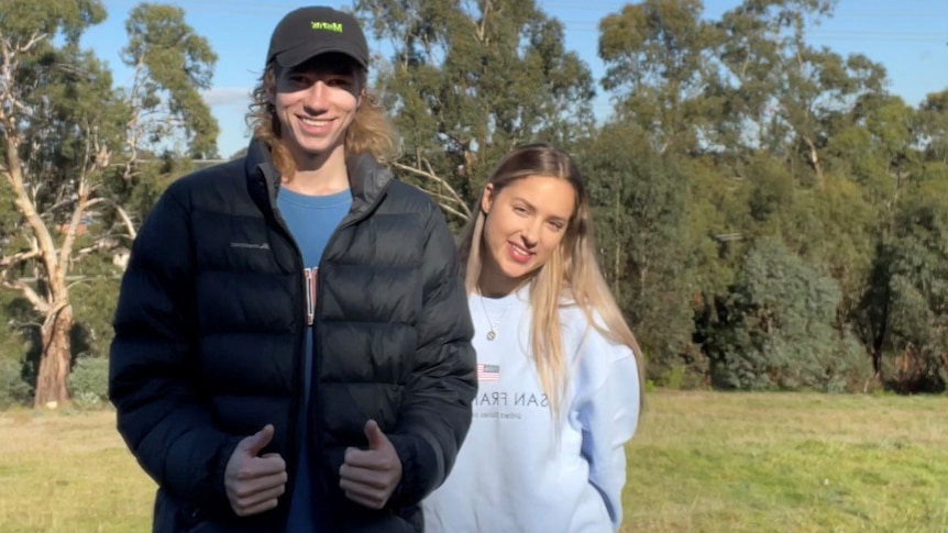 Rachel and Jarryd smile at the camera, in a story about their zero-dollar house build.