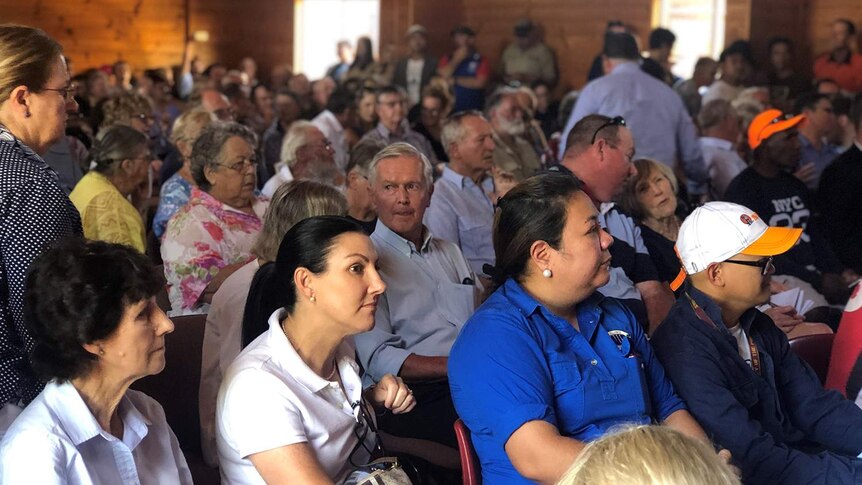 People gather at a community meeting to protest a 16km inland rail line proposed to be built on floodplain at Millmerran.