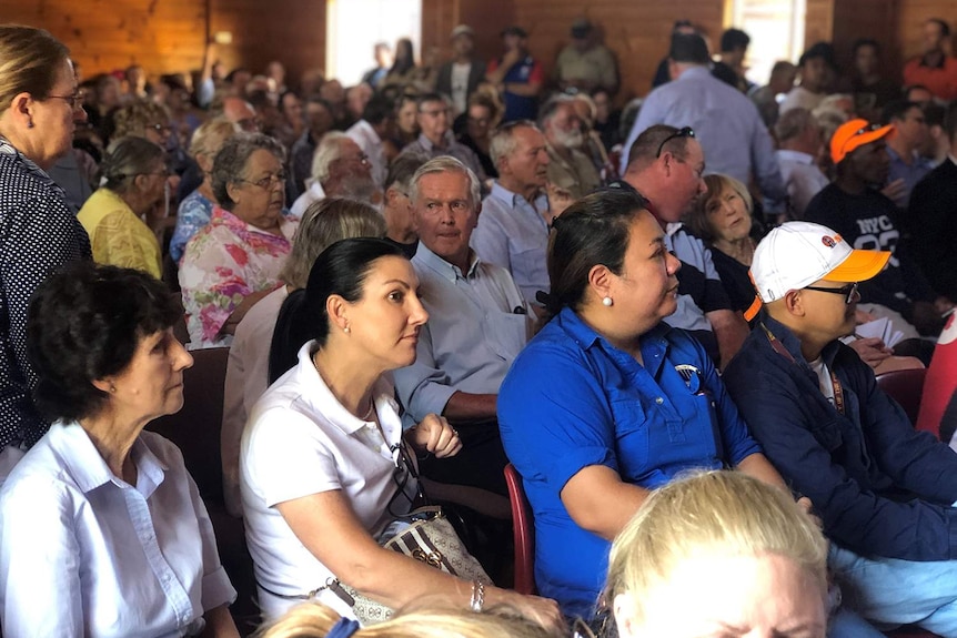 People gather at a community meeting to protest a 16km inland rail line proposed to be built on floodplain at Millmerran.